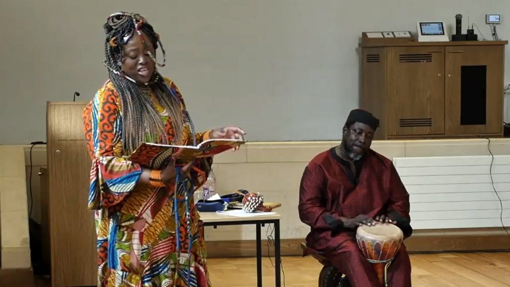 D-Empress performing "Hersto rhetoric" with seated drummer Rev J